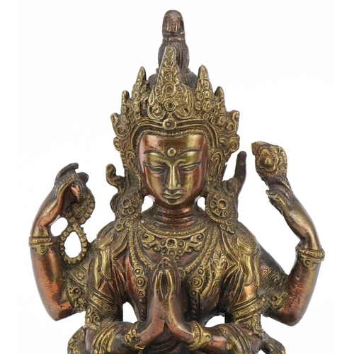 311 - Chino Tibetan partially gilt patinated bronze figure of seated Buddha, 21cm high