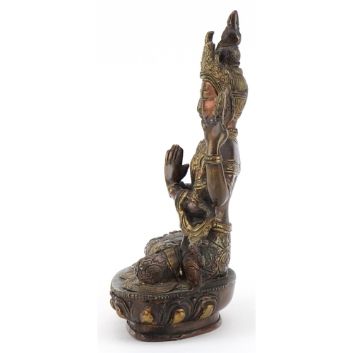 311 - Chino Tibetan partially gilt patinated bronze figure of seated Buddha, 21cm high