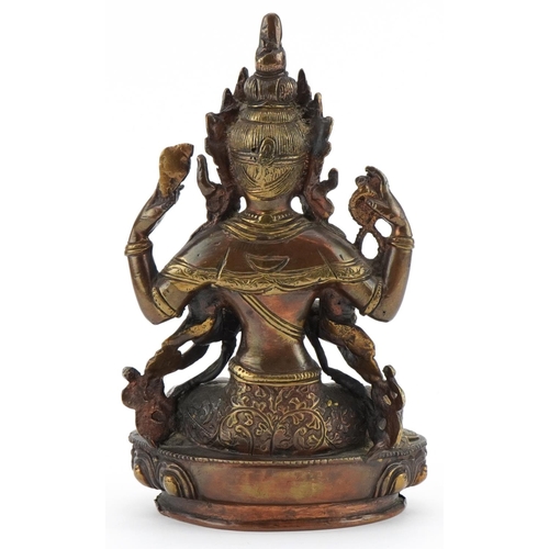 311 - Chino Tibetan partially gilt patinated bronze figure of seated Buddha, 21cm high