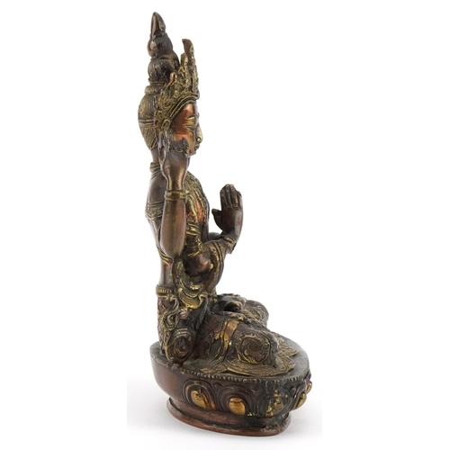 311 - Chino Tibetan partially gilt patinated bronze figure of seated Buddha, 21cm high