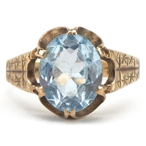 3093 - 9ct gold blue topaz solitaire ring with engine turned shoulders, the topaz approximately 10.40mm x 8... 