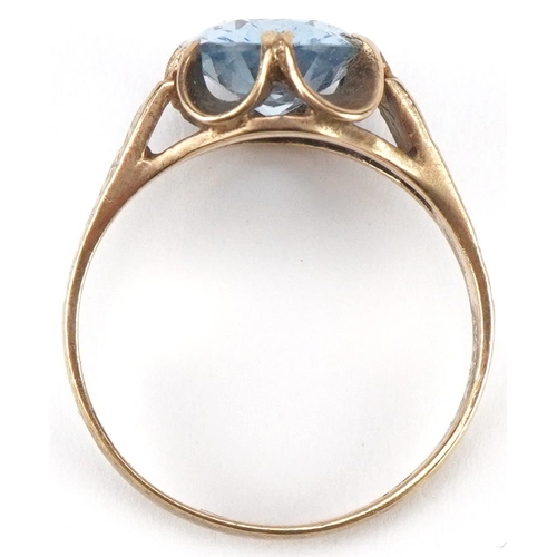 3093 - 9ct gold blue topaz solitaire ring with engine turned shoulders, the topaz approximately 10.40mm x 8... 