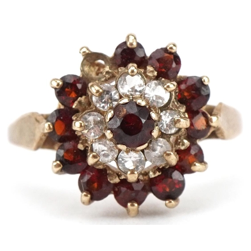 3436 - 9ct gold garnet and clear stone three tier cluster ring, size M, 2.5g