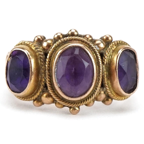 3080 - Broken unmarked gold amethyst three stone ring with ornate setting, tests as 9ct gold, 6.5g