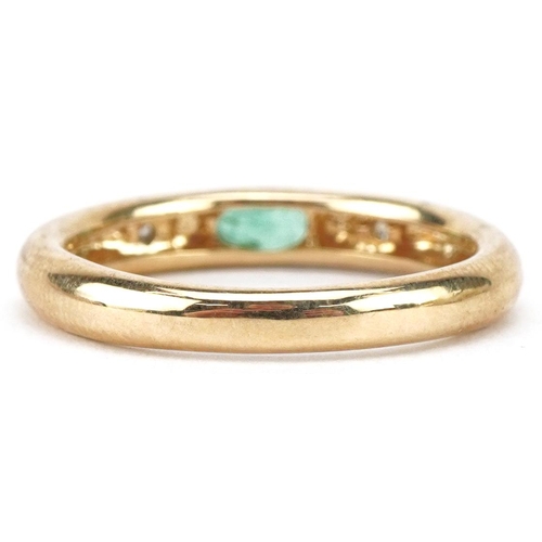 3057 - 9ct gold emerald and diamond three stone ring, size O, 2.8g