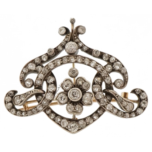 3001 - Antique unmarked yellow and white gold Belle Epoque diamond brooch pendant of scroll design with cla... 