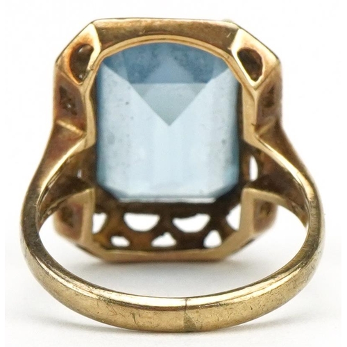 3406 - Gold baguette cut blue topaz ring with pierced setting, the topaz approximately 14.0mm x 10.20mm x 6... 