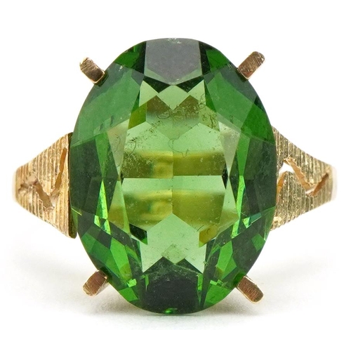 3397 - Large 9ct gold green stone ring with pierced engine turned shoulders, the stone approximately 15.9mm... 