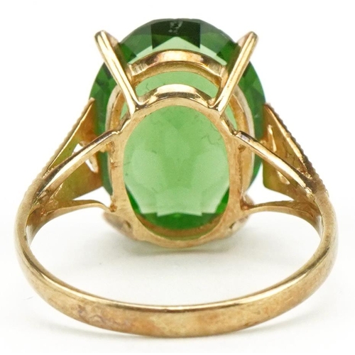 3397 - Large 9ct gold green stone ring with pierced engine turned shoulders, the stone approximately 15.9mm... 