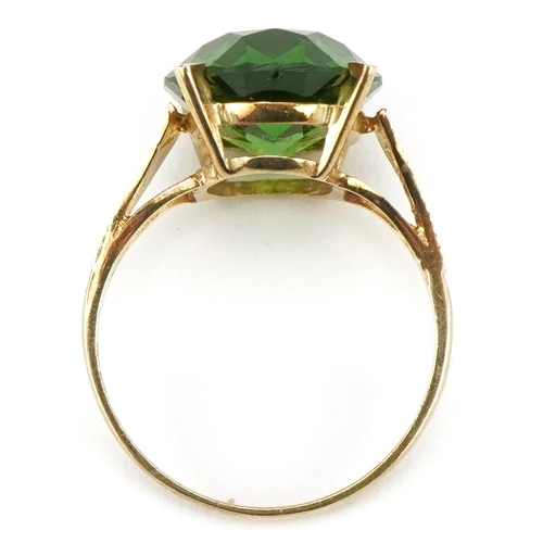 3397 - Large 9ct gold green stone ring with pierced engine turned shoulders, the stone approximately 15.9mm... 