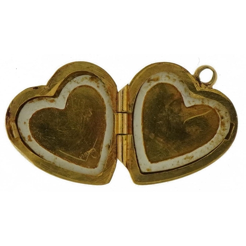 3574 - 9ct gold engine turned love heart locket, 1.6cm high, 1.5g