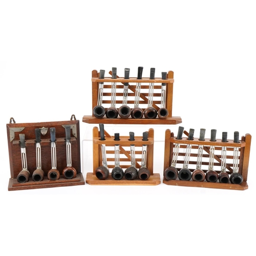 Twenty vintage Falcon aluminium and briar tobacco smoking pipes arranged in three pipe stands, three in the form of a gate, the largest pipe rack 28.5cm wide