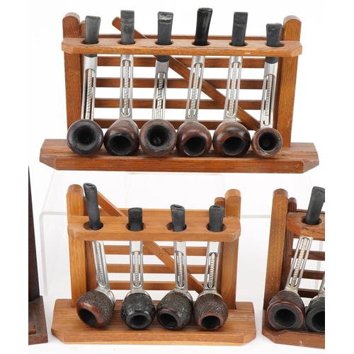 1262 - Twenty vintage Falcon aluminium and briar tobacco smoking pipes arranged in three pipe stands, three... 