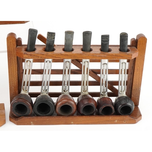 1262 - Twenty vintage Falcon aluminium and briar tobacco smoking pipes arranged in three pipe stands, three... 