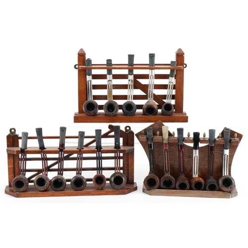 1285 - Seventeen vintage Falcon aluminium and briar tobacco smoking pipes arranged in three pipe racks, two... 