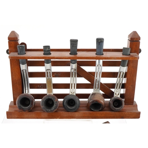 1285 - Seventeen vintage Falcon aluminium and briar tobacco smoking pipes arranged in three pipe racks, two... 