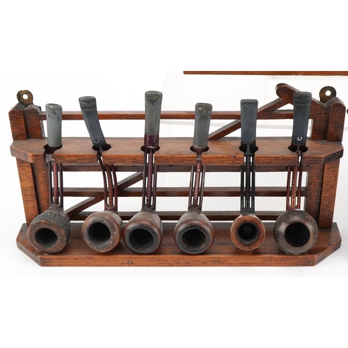 1285 - Seventeen vintage Falcon aluminium and briar tobacco smoking pipes arranged in three pipe racks, two... 