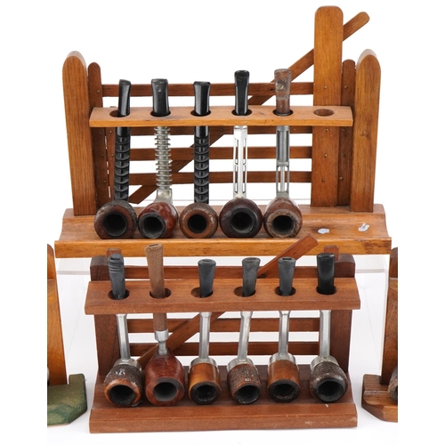 1297 - Nineteen vintage aluminium and briar tobacco smoking pipes arranged in four gate design pipe racks i... 