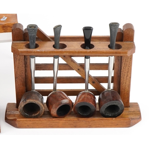 1297 - Nineteen vintage aluminium and briar tobacco smoking pipes arranged in four gate design pipe racks i... 