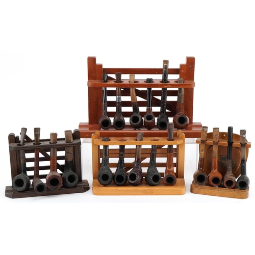 1273 - Nineteen vintage briar tobacco smoking pipes, some Italian, arranged in four pipe racks, three in th... 