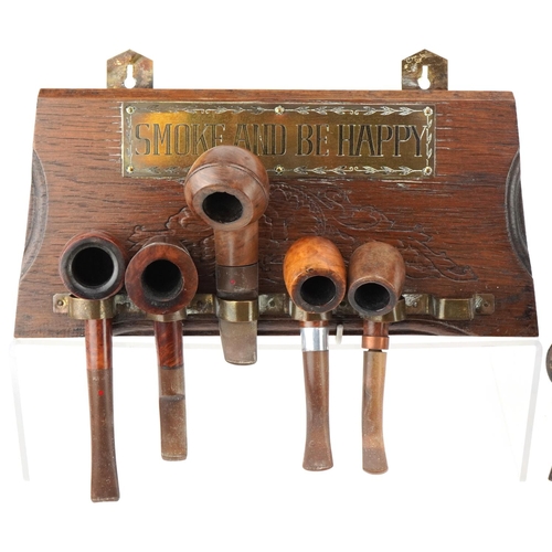 1282 - Twenty two vintage briar tobacco smoking pipes arranged in four wall hanging pipe racks, two with Sm... 