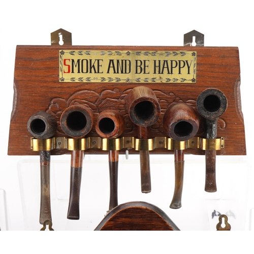 1282 - Twenty two vintage briar tobacco smoking pipes arranged in four wall hanging pipe racks, two with Sm... 