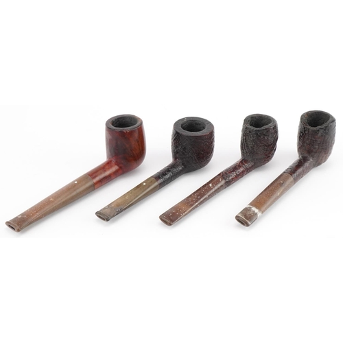 1260 - Four Dunhill briar tobacco smoking pipes arranged in a pipe rack, comprising three Shell and one Bru... 