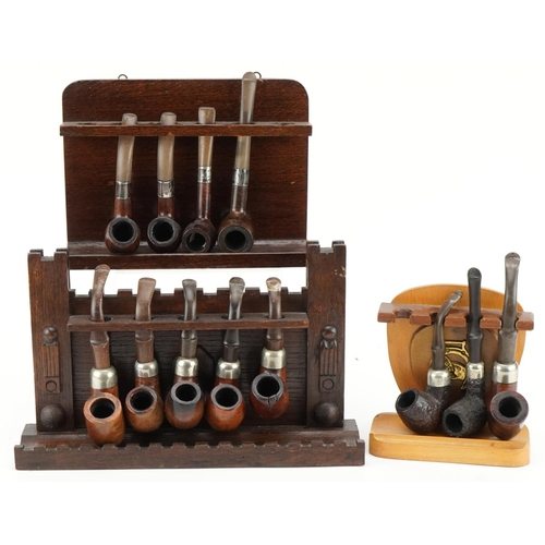 1280 - Thirteen vintage Peterson's briar tobacco smoking pipes, four with silver collars, arranged in three... 