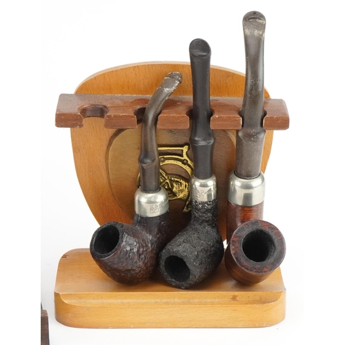 1280 - Thirteen vintage Peterson's briar tobacco smoking pipes, four with silver collars, arranged in three... 