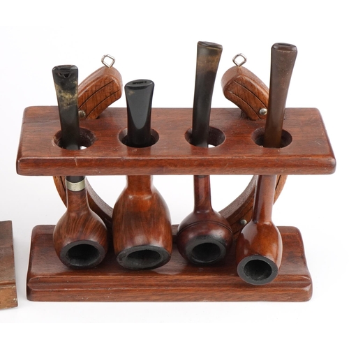 1289 - Twenty vintage tobacco smoking pipes, predominantly briar, arranged in four pipe racks comprising th... 