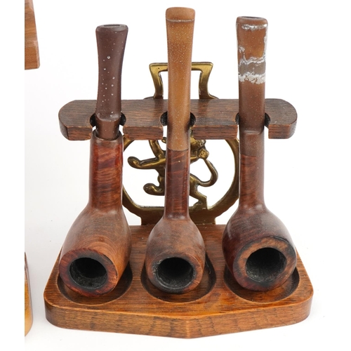 1293 - Nineteen vintage tobacco smoking pipes, predominantly briar, arranged in four pipe racks, two in the... 