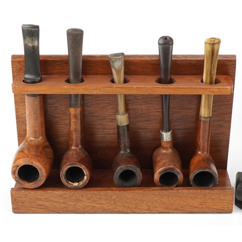 1279 - Twenty vintage briar tobacco smoking pipes arranged in four pipe racks including an oak example in t... 