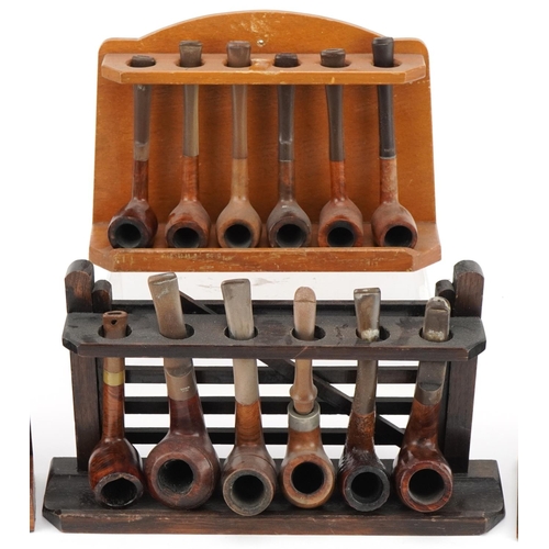 1279 - Twenty vintage briar tobacco smoking pipes arranged in four pipe racks including an oak example in t... 