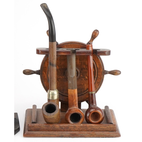 1279 - Twenty vintage briar tobacco smoking pipes arranged in four pipe racks including an oak example in t... 