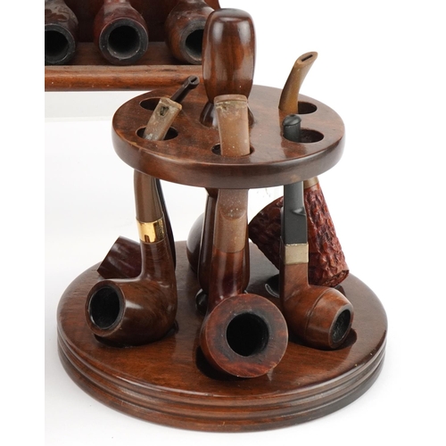 1270 - Twenty four briar tobacco smoking pipes arranged in three pipe racks including a double sided exampl... 