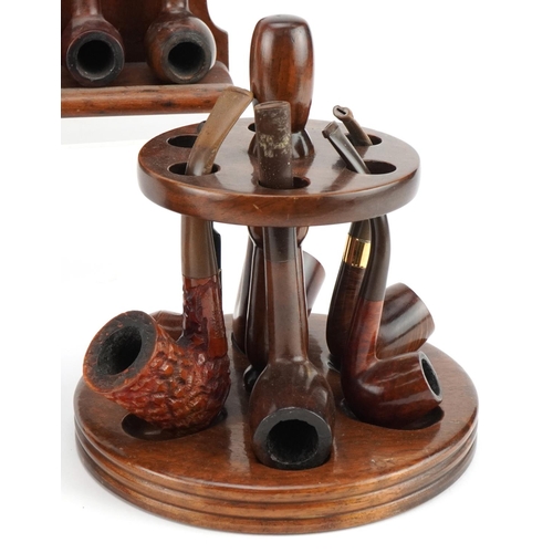 1270 - Twenty four briar tobacco smoking pipes arranged in three pipe racks including a double sided exampl... 