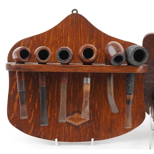 1291 - Twenty two vintage briar tobacco smoking pipes arranged in four wall hanging pipe racks including a ... 