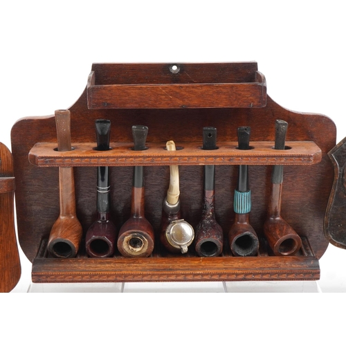 1291 - Twenty two vintage briar tobacco smoking pipes arranged in four wall hanging pipe racks including a ... 