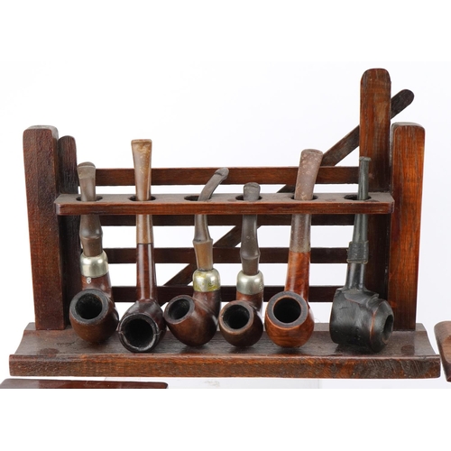 1265 - Twenty three vintage tobacco smoking pipes, predominantly briar, arranged in three pipe racks includ... 