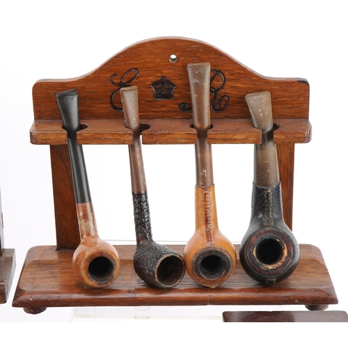 1265 - Twenty three vintage tobacco smoking pipes, predominantly briar, arranged in three pipe racks includ... 