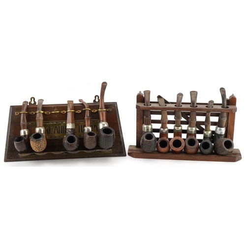 1274 - Eleven vintage Peterson's briar tobacco smoking pipes arranged in two pipe racks comprising one in t... 