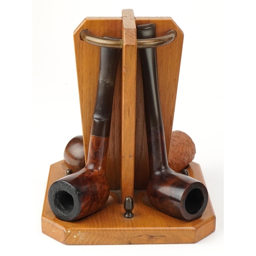 1266 - Twenty vintage tobacco smoking pipes, one with silver collar, arranged in four pipe racks and a smok... 