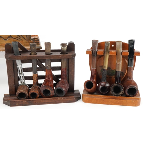 1266 - Twenty vintage tobacco smoking pipes, one with silver collar, arranged in four pipe racks and a smok... 