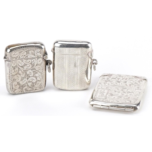 164 - Two Edwardian and later silver vestas and a silver match case with gilt interior, the largest 6cm in... 