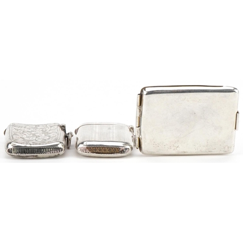 164 - Two Edwardian and later silver vestas and a silver match case with gilt interior, the largest 6cm in... 