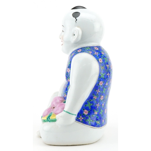 522 - Chinese porcelain figure of a young boy holding fruit, 30cm high