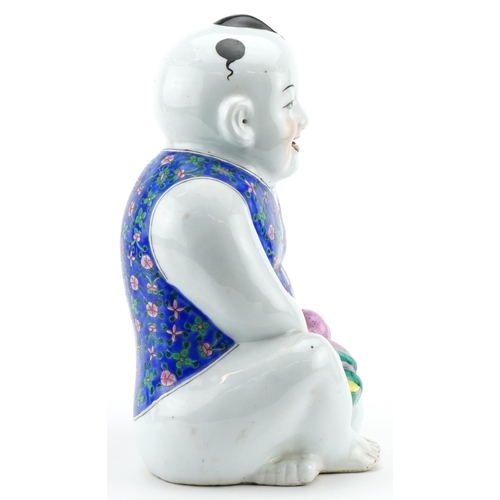 522 - Chinese porcelain figure of a young boy holding fruit, 30cm high