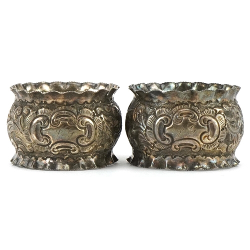 690 - J Sherwood & Sons, pair of Victorian silver napkin rings embossed with flowers and foliage, housed i... 