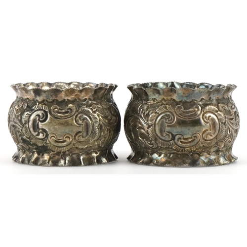 690 - J Sherwood & Sons, pair of Victorian silver napkin rings embossed with flowers and foliage, housed i... 