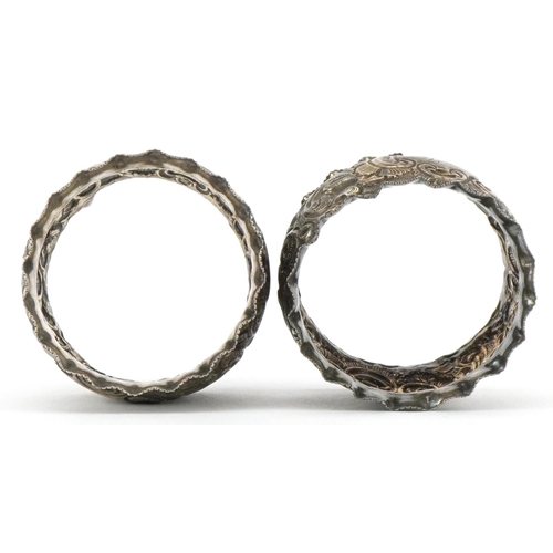 690 - J Sherwood & Sons, pair of Victorian silver napkin rings embossed with flowers and foliage, housed i... 